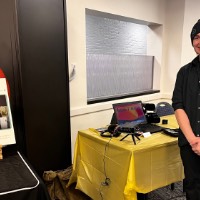 Kailey Barker and Andrew Nemeth posing with their tables that show their work